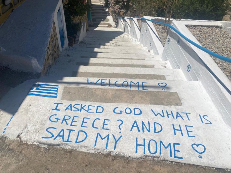 Written Text on a stairway on Kalymnos that says 'I asked God what is Greece? And he said my home!'